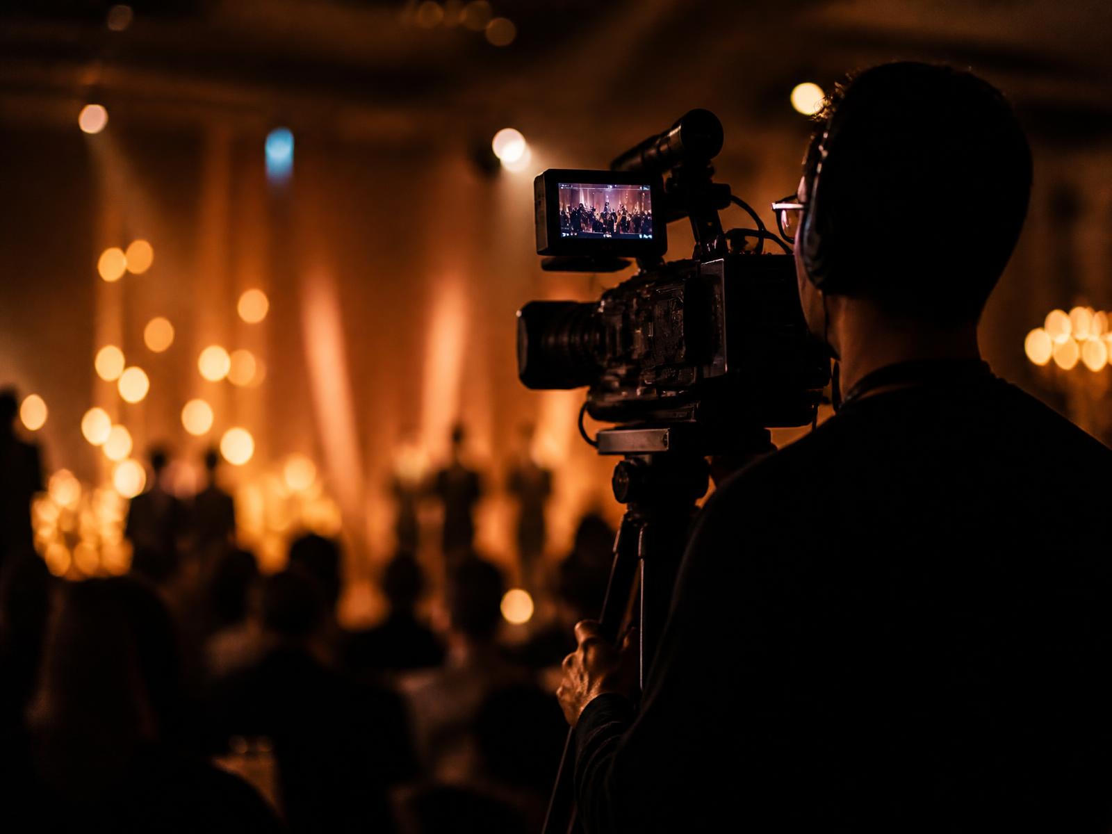 Videographer filming a live event with a cinema camera